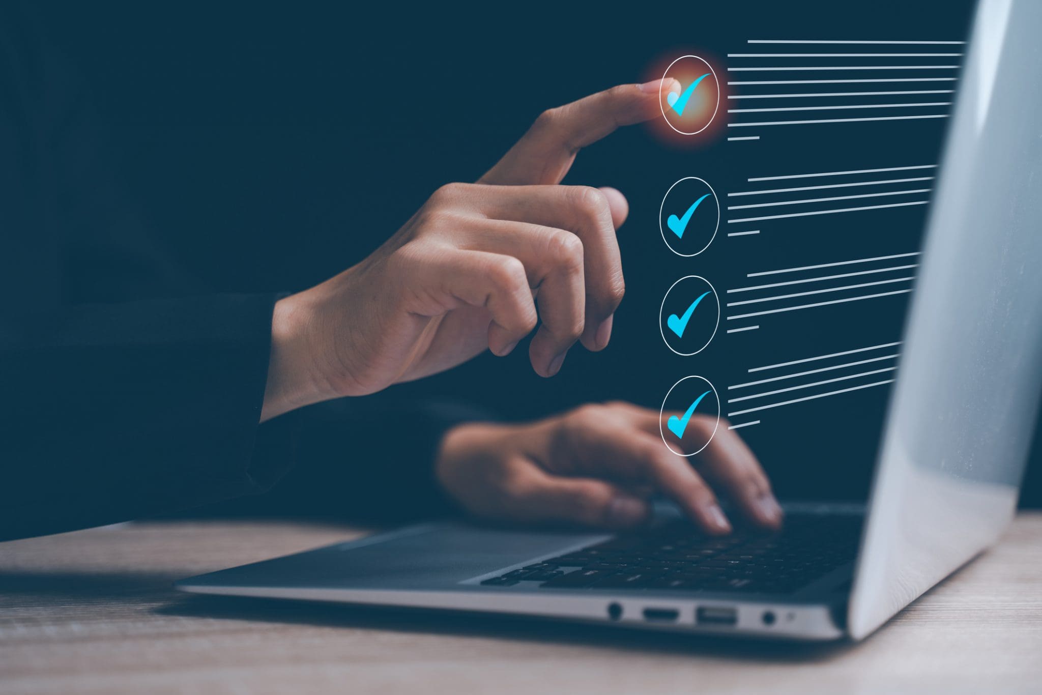 Businesswoman, checklist, document, online, and desk describe this scene of a professional woman interacting with a digital form at her workstation.