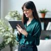 Shot of female psychologist using digital table while standing in her office