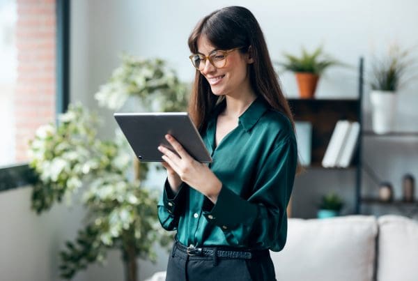 Shot of female psychologist using digital table while standing in her office