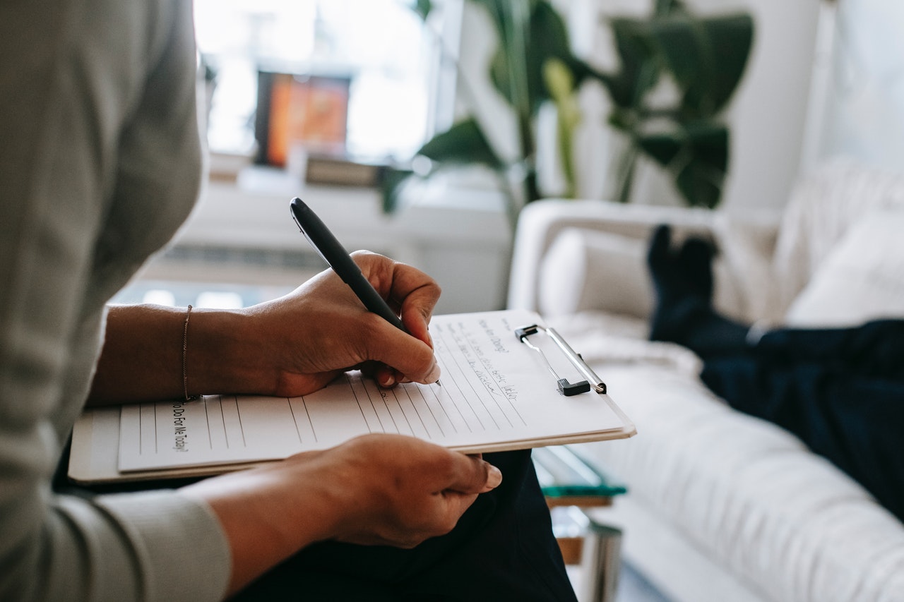 Psychologist Taking Notes on a Clipboard - icd-10 codes for depression