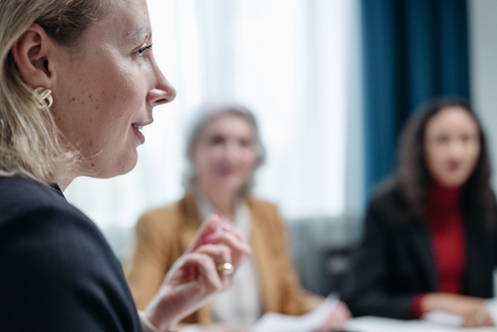 Psychologist speaking to colleagues at group psychotherapy practice