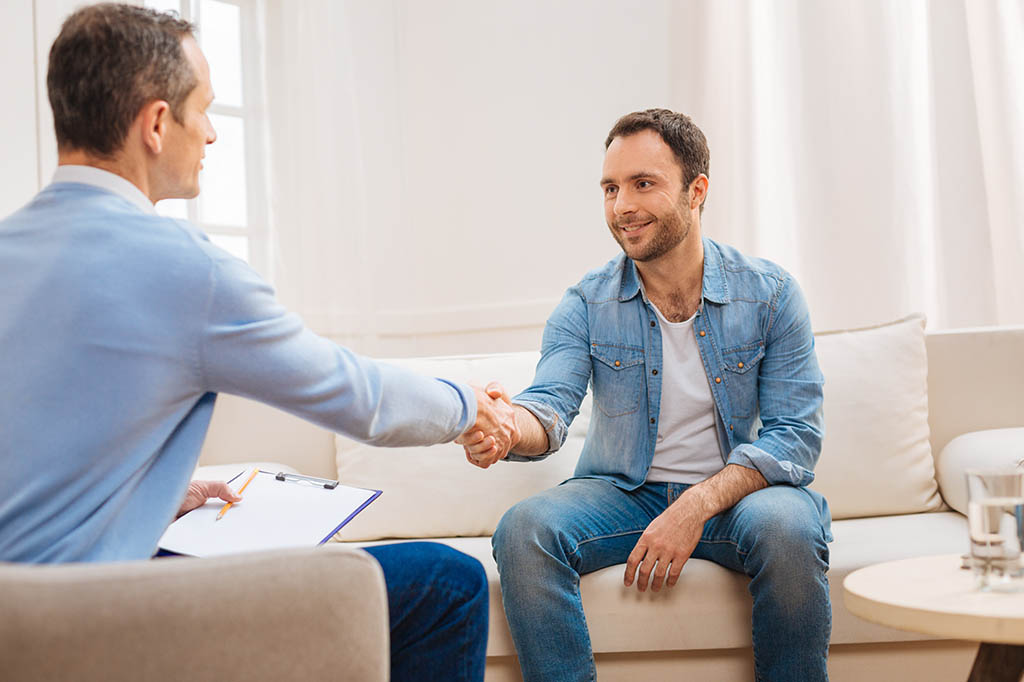 clinician and patient shaking hands