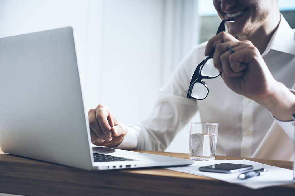 clinician working on laptop