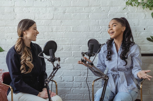 women speaking at microphones