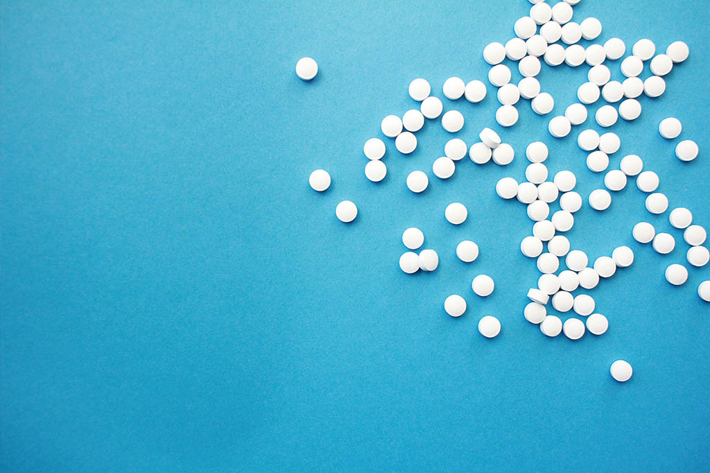 round white pills on light blue background