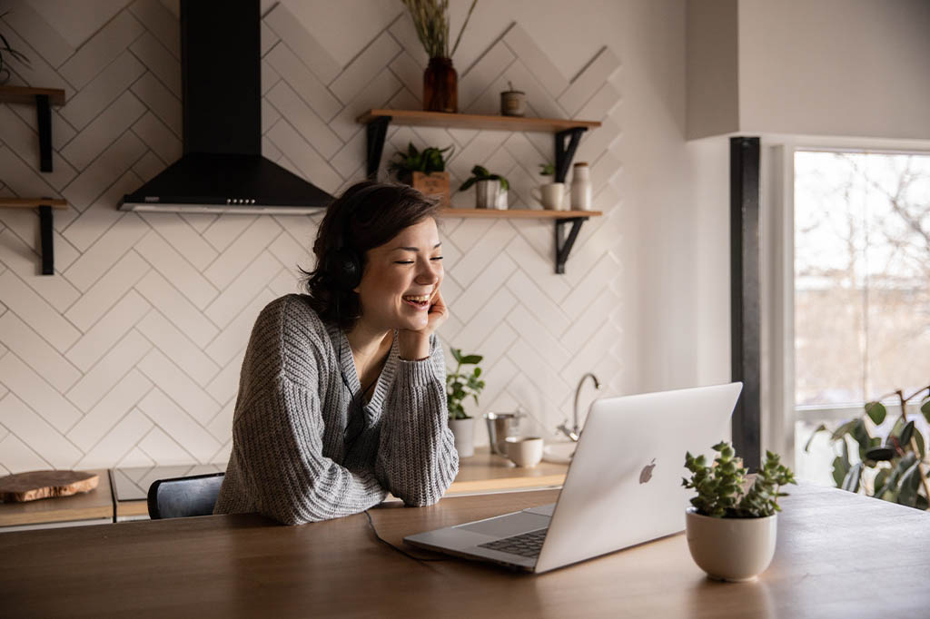 woman using telehealth on laptop