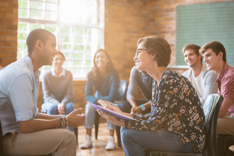 Clinician works with patients in a group therapy session