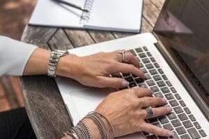 person opening PMHNP private practice on laptop