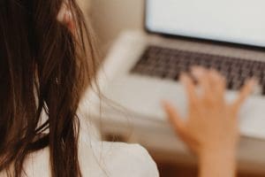 woman setting up PMHNP documentation on laptop
