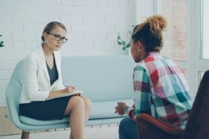 psychiatrist and patient speaking in office