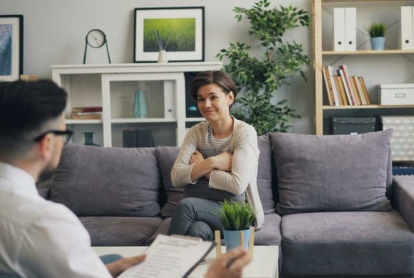 patient sitting across from psychiatrist in office