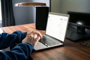 person working on a brightly lit laptop