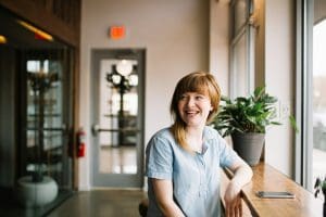 woman smiling sitting at commercial space