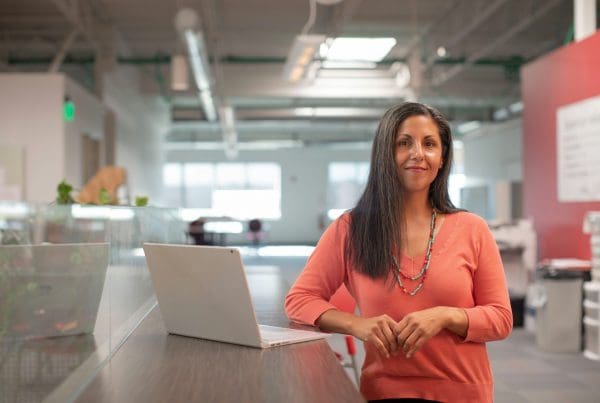 woman with laptop open on desk