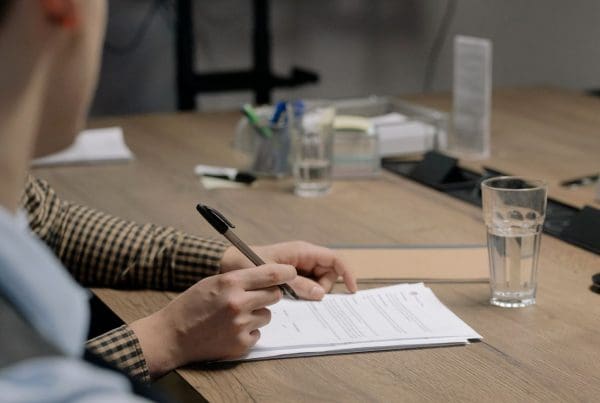 person taking notes at a desk
