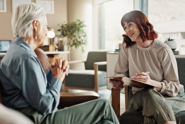 female clinician speaking with client in office