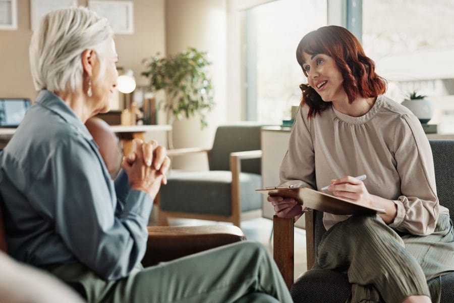 female clinician speaking with client in office